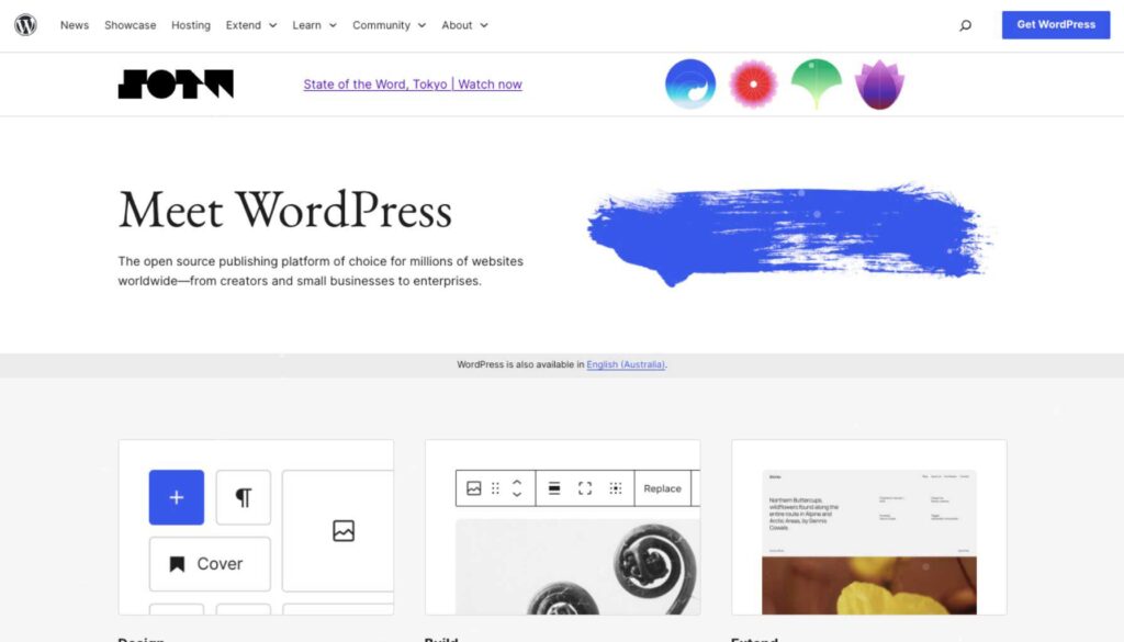 A webpage featuring the WordPress logo and a prominent heading that reads "Meet WordPress." Below the heading, there is a brief description highlighting WordPress as an open-source publishing platform for various users, including creators and businesses. The page includes sections labeled "Design," "Build," and "Extend," with icons and images representing different features or tools related to WordPress. A blue brushstroke graphic is also present, adding a visual element to the design. The top navigation bar includes links for news, hosting, community, and a button to "Get WordPress.
